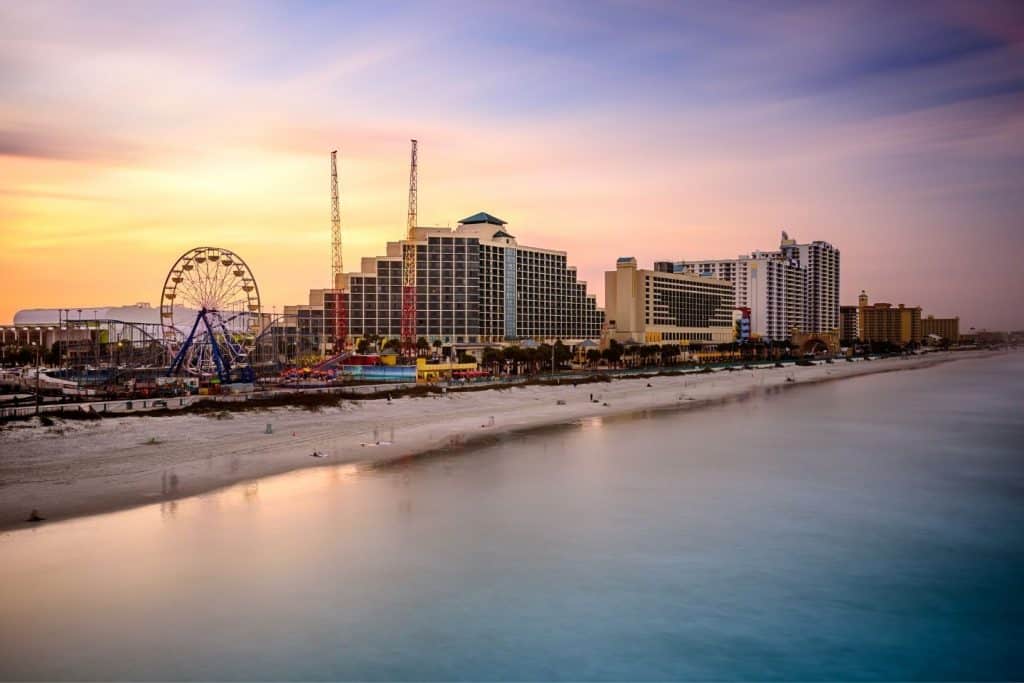 Daytona beach at sunset with a view of the big hotels and the ferris wheel