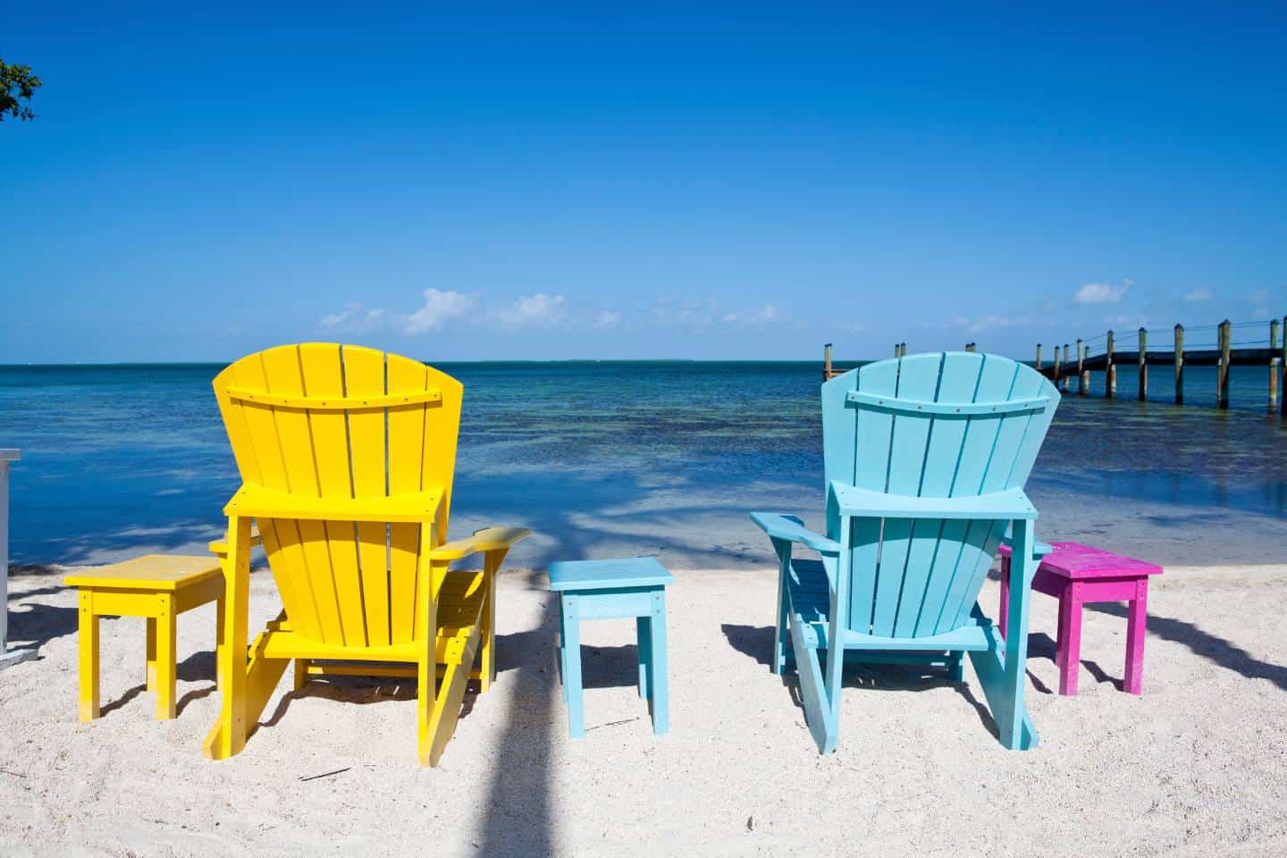 Bright Colored beach chairs looking out at the ocean